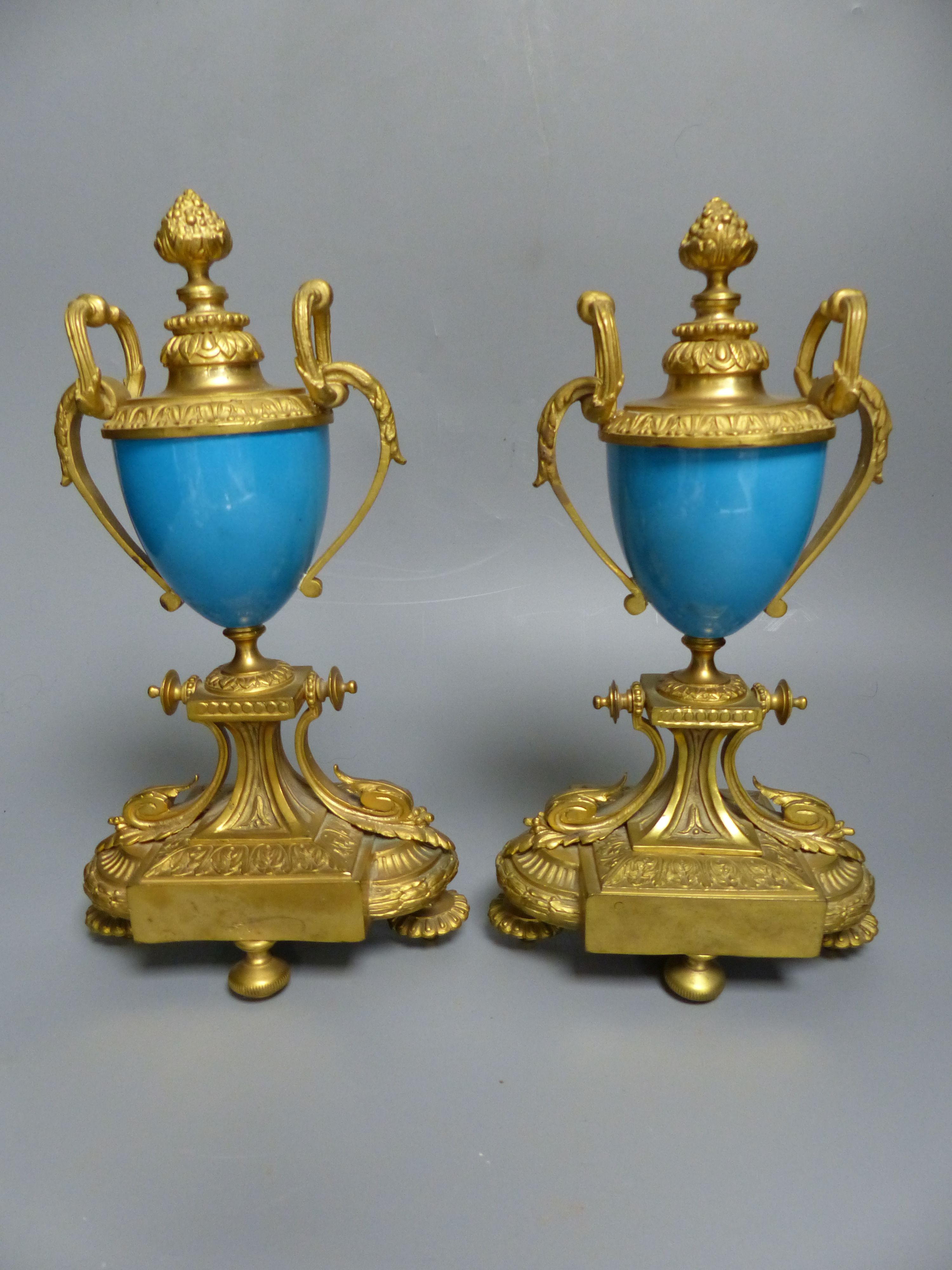 A pair of 19th century French ormolu and Sevres style porcelain urns, decorated with flowers and landscapes, height 26.5cm